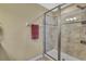 A bathroom featuring a glass shower with granite-look tile, a towel bar, and neutral walls at 2387 Bartolo Dr, Land O Lakes, FL 34639