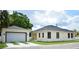 View of exterior of a home and detached garage with new roof and landscaping at 2504 E 28Th Ave, Tampa, FL 33605