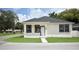 Charming single-story home with a well-manicured lawn and classic black and white trim at 2504 E 28Th Ave, Tampa, FL 33605