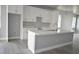 An open concept kitchen and living area, showcasing white cabinets, island, and modern lighting at 2504 E 28Th Ave, Tampa, FL 33605