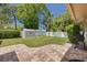 Spacious backyard with brick patio, shed, and lush landscaping at 2550 Rolling View Dr, Dunedin, FL 34698