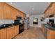 Well-equipped kitchen with stainless steel appliances, granite countertops, wooden cabinets, and tile flooring at 2550 Rolling View Dr, Dunedin, FL 34698