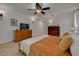 Comfortable main bedroom featuring wood-look floors, ceiling fan and stylish decor at 2550 Rolling View Dr, Dunedin, FL 34698