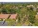 Aerial view of a residential neighborhood showing tree coverage, parking, and building structures at 2640 Woodgate Ln # F6, Sarasota, FL 34231