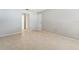 Open view of bedroom featuring neutral walls, tile flooring, and closet doors at 2640 Woodgate Ln # F6, Sarasota, FL 34231