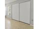 Spacious closet featuring sliding doors, a window, and tile flooring for added convenience at 2640 Woodgate Ln # F6, Sarasota, FL 34231