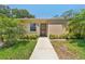 Charming single-story home with a well-maintained lawn and lush tropical landscaping at 2640 Woodgate Ln # F6, Sarasota, FL 34231