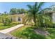 Inviting one-story home showcasing a well-kept lawn and vibrant tropical foliage at 2640 Woodgate Ln # F6, Sarasota, FL 34231