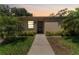 Charming single-story home with a well-maintained lawn and lush tropical landscaping at 2640 Woodgate Ln # F6, Sarasota, FL 34231