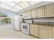 Bright kitchen features tile floors, white appliances, granite counters, and ample cabinet space at 2640 Woodgate Ln # F6, Sarasota, FL 34231
