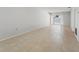 Bright living room featuring neutral walls and tile flooring, with sliding glass doors to the outside patio at 2640 Woodgate Ln # F6, Sarasota, FL 34231