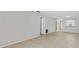 Open living room with neutral walls and tile flooring, leading to other rooms including the kitchen bar at 2640 Woodgate Ln # F6, Sarasota, FL 34231