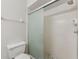 Bathroom featuring a toilet and a glass-enclosed shower with neutral walls at 2640 Woodgate Ln # F6, Sarasota, FL 34231