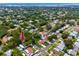 An aerial view of a charming home nestled among lush trees in a quiet residential neighborhood near the bay at 2662 Oakbrook Dr, Largo, FL 33770