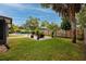 Serene backyard with a swimming pool, a patio seating area, and lush landscaping at 2662 Oakbrook Dr, Largo, FL 33770
