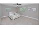 Bright bedroom featuring a comfortable bed with decorative pillows, complemented by tiled floors and natural light from windows at 2662 Oakbrook Dr, Largo, FL 33770
