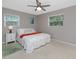Well-lit bedroom features a plush bed and decorative pillows, complemented by a white nightstand and green rug at 2662 Oakbrook Dr, Largo, FL 33770