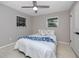 Cozy bedroom with a ceiling fan, a comfortable bed with decorative pillows and a blue blanket at 2662 Oakbrook Dr, Largo, FL 33770