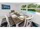 Bright dining area with pool view, modern table setting, and stylish decor at 2662 Oakbrook Dr, Largo, FL 33770