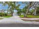Charming single-story home with mature trees, a spacious driveway, and green lawn at 2662 Oakbrook Dr, Largo, FL 33770