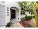 Inviting front entrance with a black door, decorative light, and tiled walkway at 2662 Oakbrook Dr, Largo, FL 33770