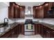 Well-appointed kitchen featuring granite counters, stainless appliances, and stylish cabinetry at 2662 Oakbrook Dr, Largo, FL 33770