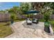 Relaxing backyard patio with seating area and well-manicured landscaping, perfect for outdoor enjoyment at 2662 Oakbrook Dr, Largo, FL 33770