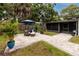 Inviting brick patio featuring comfortable seating and lush tropical landscaping, ideal for relaxation at 2662 Oakbrook Dr, Largo, FL 33770