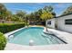 Backyard pool area with lush landscaping, offering a private oasis for relaxation and recreation at 2662 Oakbrook Dr, Largo, FL 33770