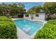 Pool area with tropical landscaping, offering a private oasis for relaxation and recreation at 2662 Oakbrook Dr, Largo, FL 33770