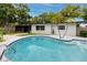 Sparkling pool with surrounding patio and landscaping, creating a private oasis for outdoor fun at 2662 Oakbrook Dr, Largo, FL 33770