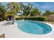 Private backyard pool surrounded by lush greenery, offering a serene retreat at 2662 Oakbrook Dr, Largo, FL 33770