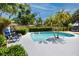 Refreshing pool area with lounge chairs and tropical landscaping, ideal for relaxation and entertaining at 2662 Oakbrook Dr, Largo, FL 33770