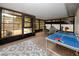 Enclosed sun room with natural light, and a ping pong table for recreation and relaxation at 2662 Oakbrook Dr, Largo, FL 33770