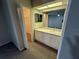 Bathroom with vanity and view to a closet and Primary bedroom at 2826 Rampart Cir, Clearwater, FL 33761