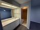Bathroom featuring a single sink vanity, large mirror, and a walk-in shower at 2826 Rampart Cir, Clearwater, FL 33761