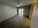 Bedroom features sliding door to patio, carpet, and natural light at 2826 Rampart Cir, Clearwater, FL 33761