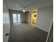 Spacious bedroom featuring a ceiling fan and sliding glass doors to the outside at 2826 Rampart Cir, Clearwater, FL 33761