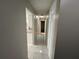 Hallway with tile flooring, light neutral walls, and white doors leading to various rooms at 2826 Rampart Cir, Clearwater, FL 33761