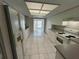 Clean kitchen featuring ample white cabinetry, tile floors, and modern appliances at 2826 Rampart Cir, Clearwater, FL 33761