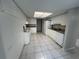Kitchen featuring white cabinets, tile floors, and appliances at 2826 Rampart Cir, Clearwater, FL 33761