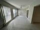 Enclosed lanai with tiled floors, ceiling fan, and abundant natural light through multiple windows at 2826 Rampart Cir, Clearwater, FL 33761
