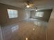 Bright living room with tile flooring, ceiling fans, and natural light at 2826 Rampart Cir, Clearwater, FL 33761