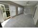 Relaxing enclosed patio with tile floor, ceiling fan, and open access to the backyard at 2826 Rampart Cir, Clearwater, FL 33761