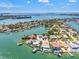 Breathtaking aerial view showcases a coastal neighborhood with waterfront homes, canals and bridge at 3021 Alton Dr, St Pete Beach, FL 33706