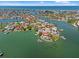Expansive aerial view of a coastal neighborhood featuring waterfront homes and serene canals at 3021 Alton Dr, St Pete Beach, FL 33706
