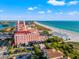 Spectacular aerial view of a historic pink hotel next to a pristine beach at 3021 Alton Dr, St Pete Beach, FL 33706