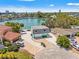 Aerial view of a charming home with a private dock, surrounded by lush landscaping and serene waters at 3021 Alton Dr, St Pete Beach, FL 33706