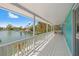 Wide, waterfront balcony that overlooks canal, docks, and other waterfront homes at 3021 Alton Dr, St Pete Beach, FL 33706