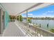 Expansive waterfront view from a large white balcony with palm trees and a private dock at 3021 Alton Dr, St Pete Beach, FL 33706